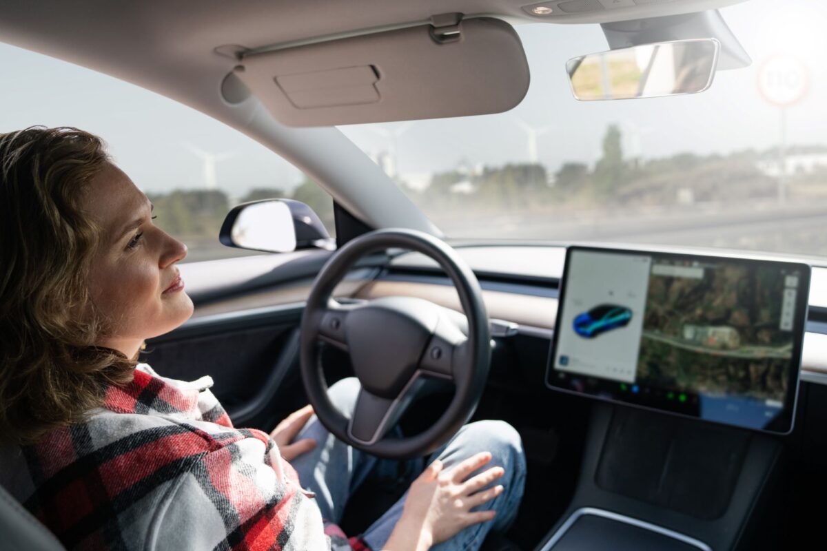 Woman resting in her car during automated driving